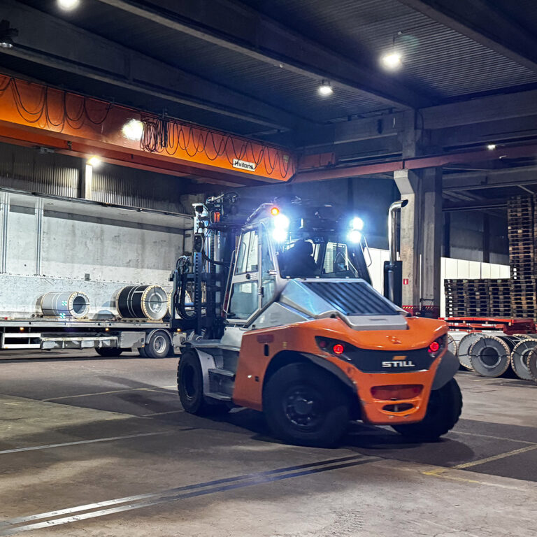 Truck som lastar material på en lastbil - LBC Frakts lager.